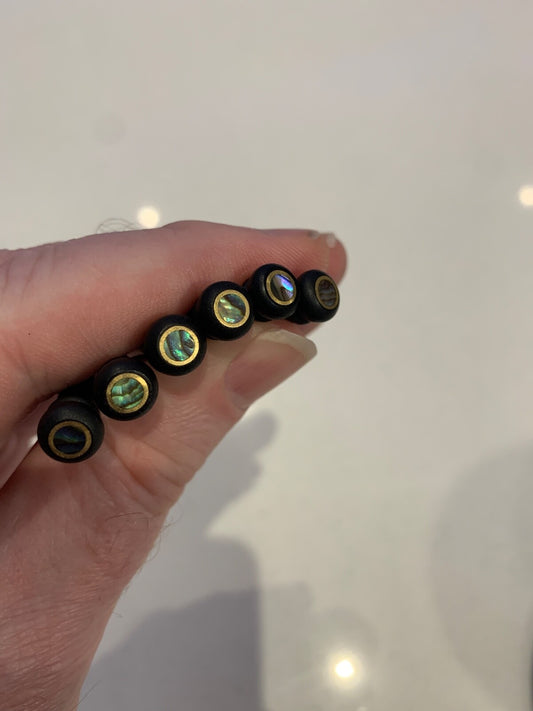 6 x Ebony Guitar Bridge Pins with Abalone & Brass photographed against a white background.