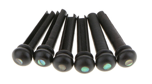 Six Ebony Acoustic Guitar Bridge Pins with Abalone dots against a white background.