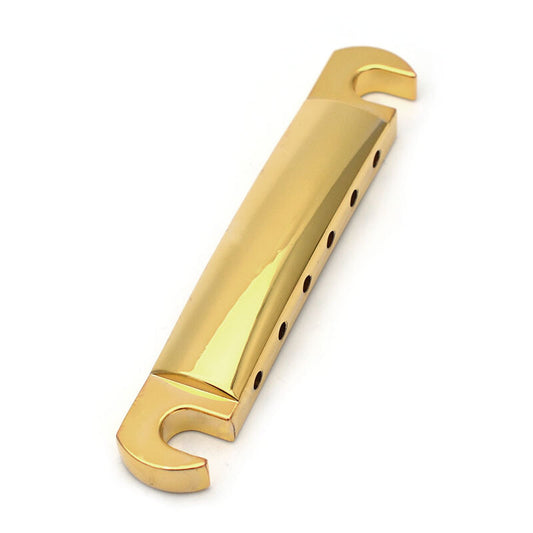Electric guitar tailbar in gold colour on a white background.