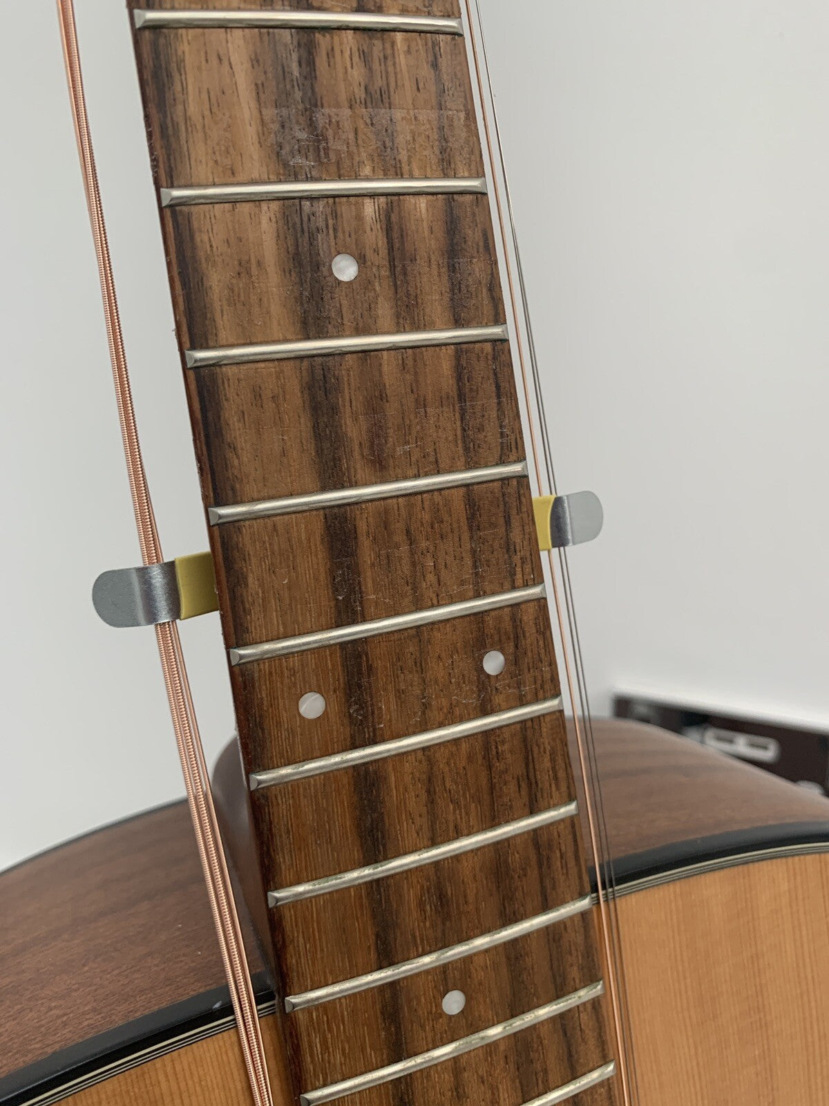 A Guitar String Spreader on the bottom of a guitar's neck.