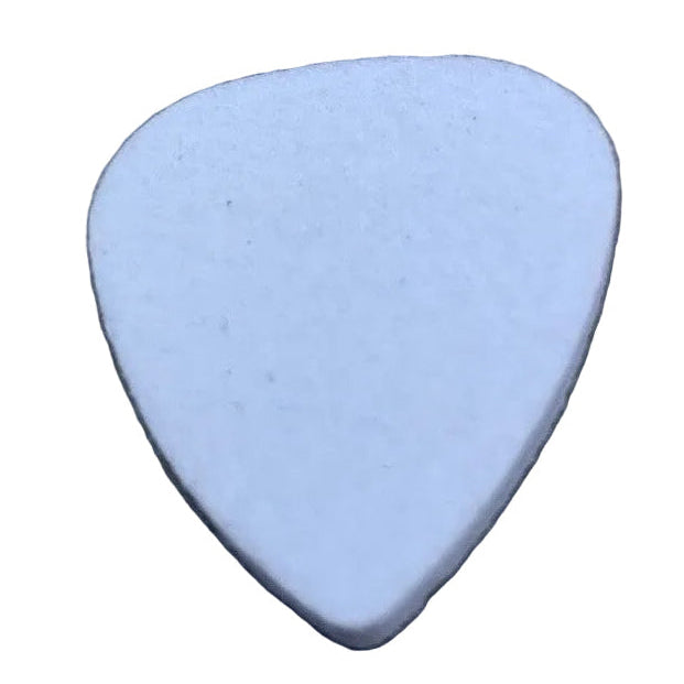 White felt guitar pick ('plectrum') on a textured grey surface.