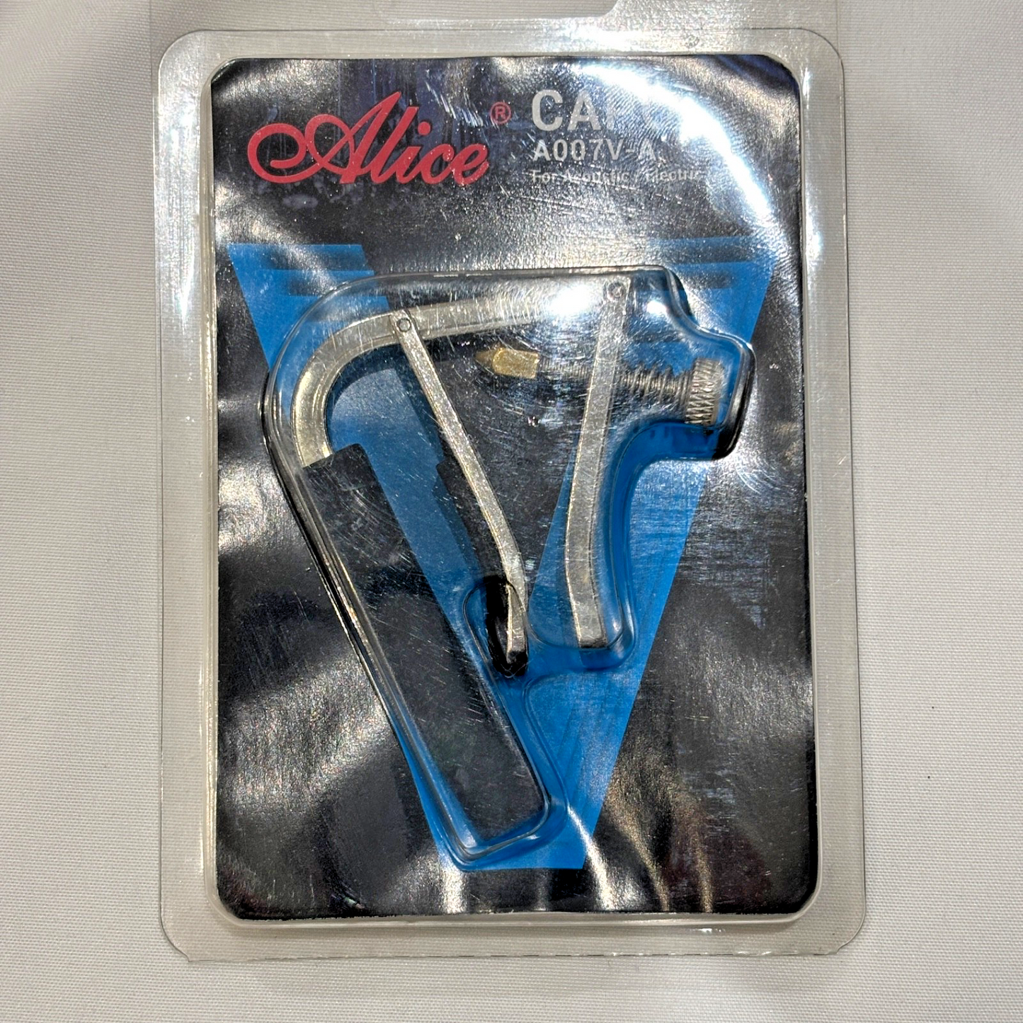 Blue and silver guitar capo in packaging with 'Alice' branding on a gray background