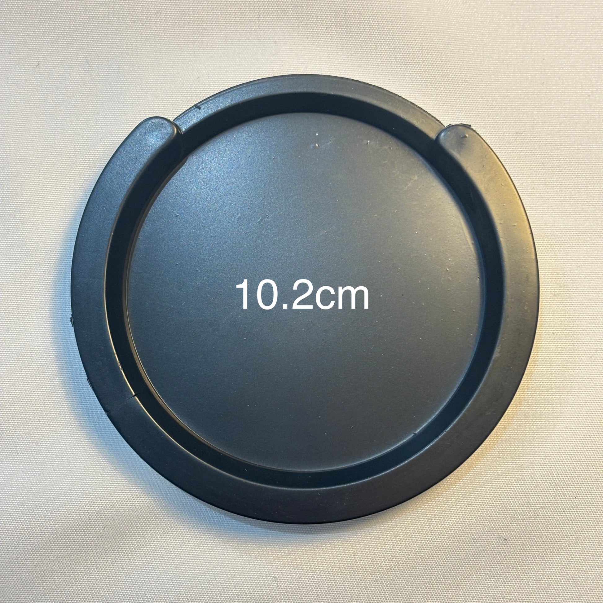 A large acoustic guitar Feedback Buster / Suppressor  on a light grey surface.