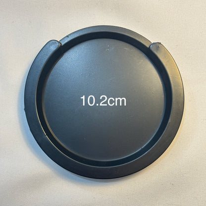 A large acoustic guitar Feedback Buster / Suppressor  on a light grey surface.