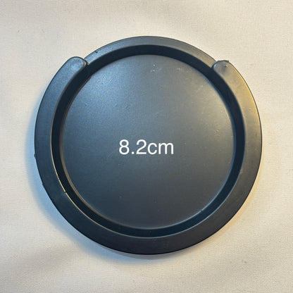 A small acoustic guitar Feedback Buster / Suppressor  on a light grey surface.