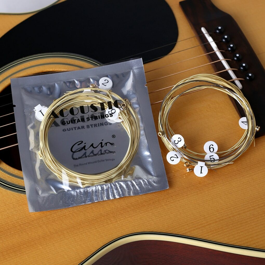 Acoustic Guitar Strings with packaging on an acoustic guitar