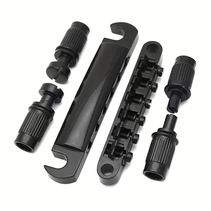 Electric Guitar bridge kit LP style in black against a white background.