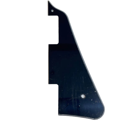 Black electric guitar pickguard, LP-compatible, on a white surface.