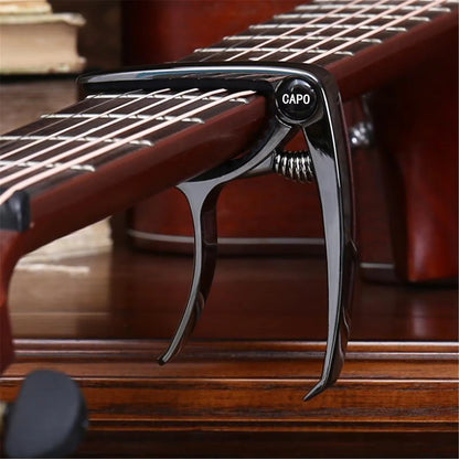 Guitar capo on a guitar with a blurred background