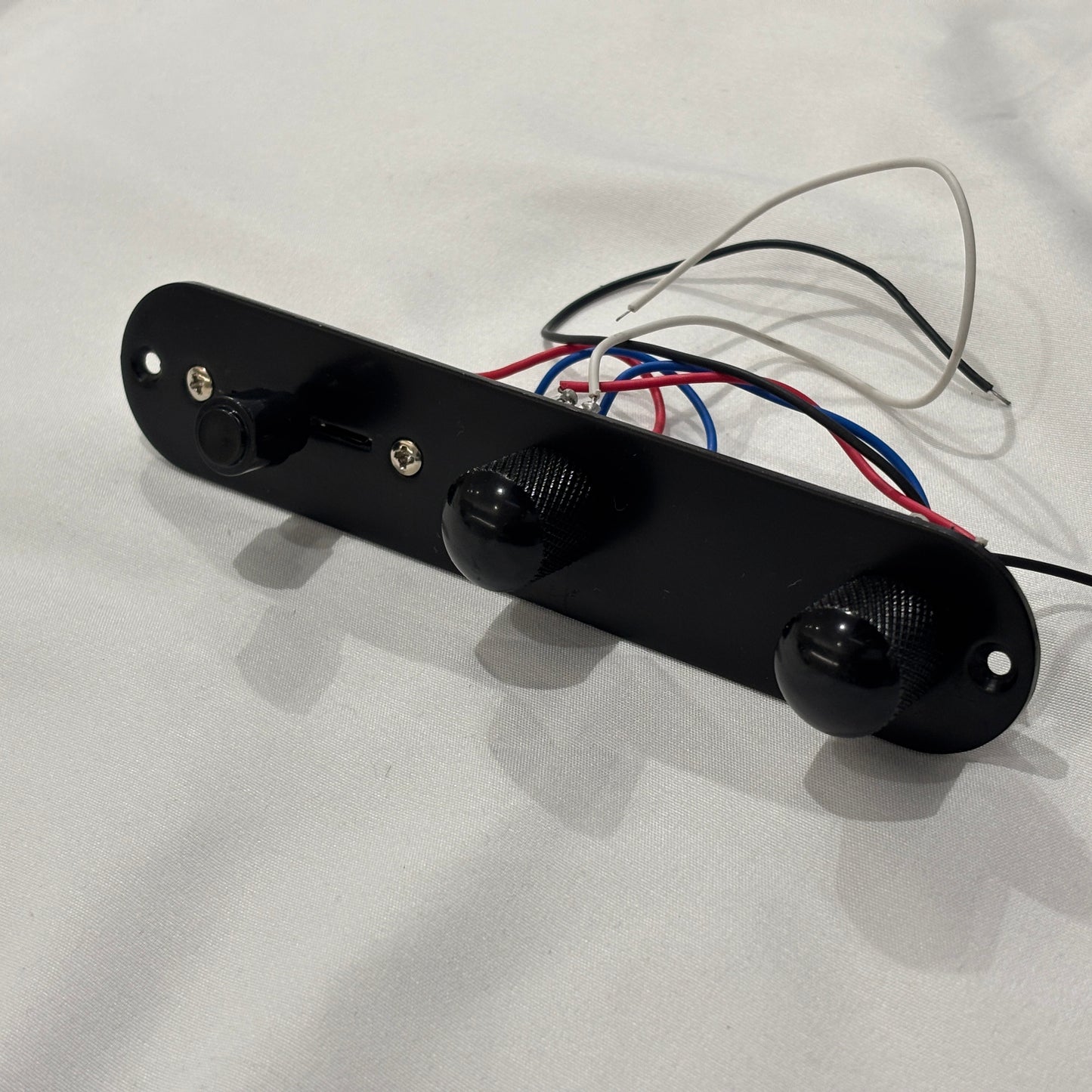 Black loaded  TL-style Control Plate against a white background.