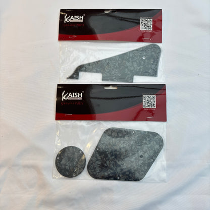 Black pearl pickguard set, LP-compatible, on a white surface.