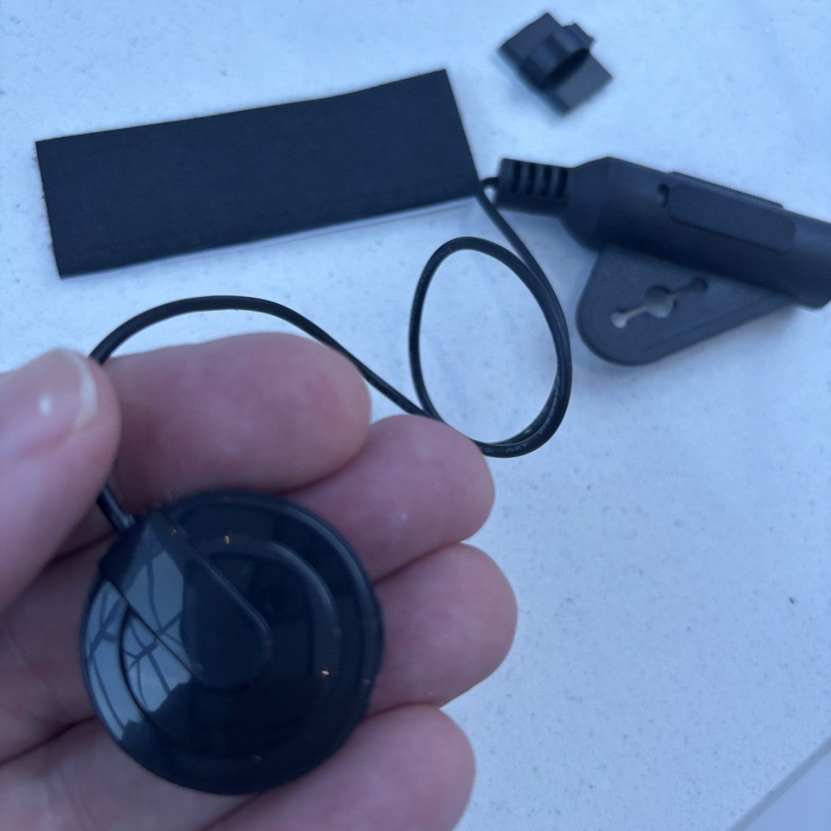 Black Piezo Guitar pickup in a persons hand.