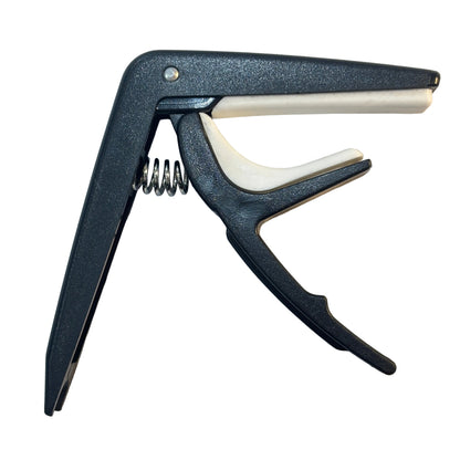Black guitar capo on a white background
