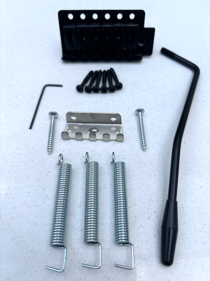 Black Tremolo Guitar Bridge Kit, ST-style, on a white background.