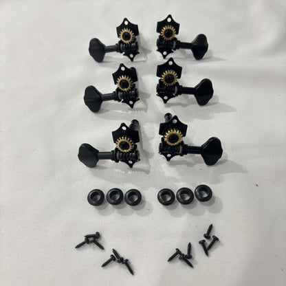 Set of black open back vintage acoustic guitar machine heads and fixings on a white background