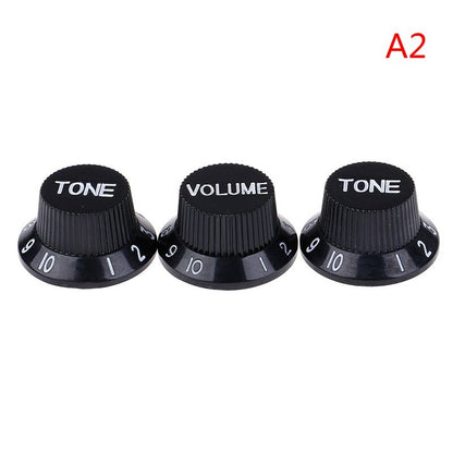 Three Black electric guitar Control Knobs,  labeled 'TONE' and 'VOLUME', ST-style, in White text on a white background.