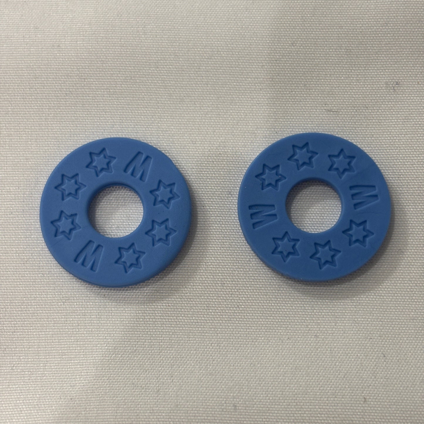 Two Blue Rubber Guitar Strap Locks on a light grey background.