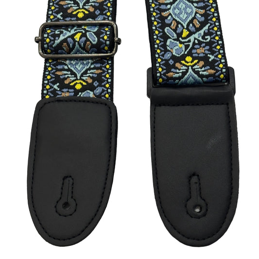 Close up of the ends of a Blue, Yellow and Black Embroidered Guitar Strap on a white background.