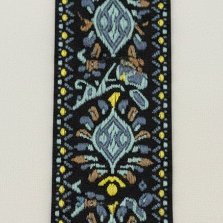 Close up of a Blue, Yellow and Black Embroidered Guitar Strap pattern on a white background.