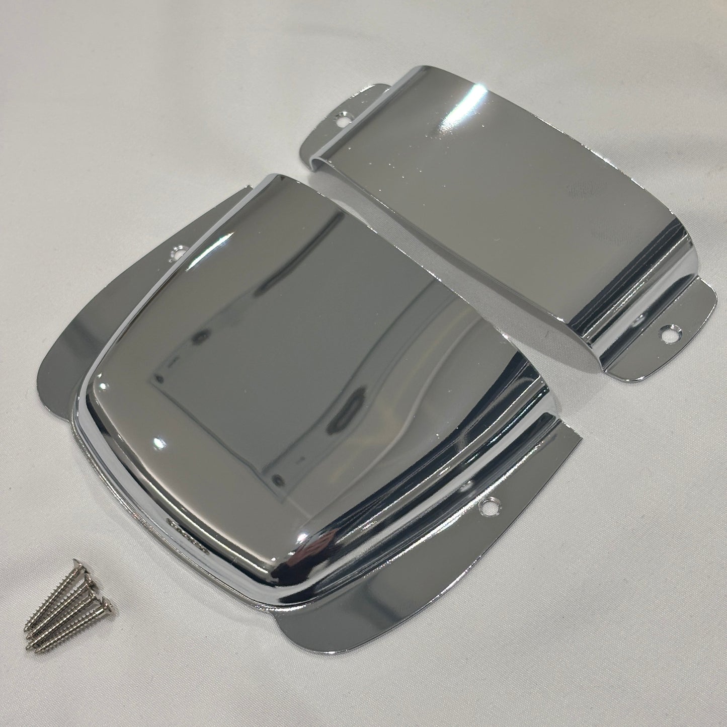Chrome Bass Guitar Bridge and Pickup Covers photographed from the side on a White background.