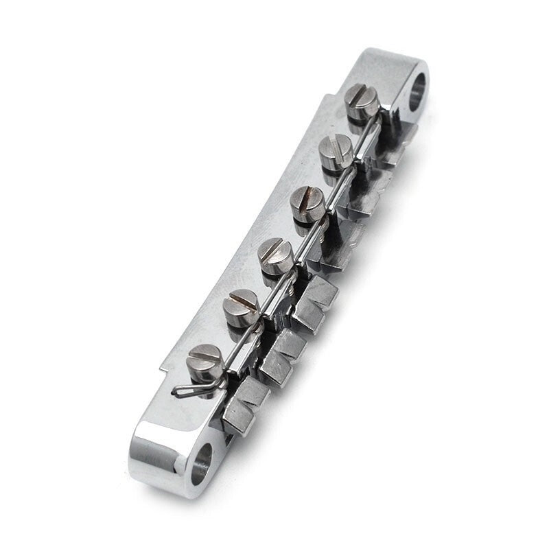 Electric Guitar bridge in chrome against a white background.