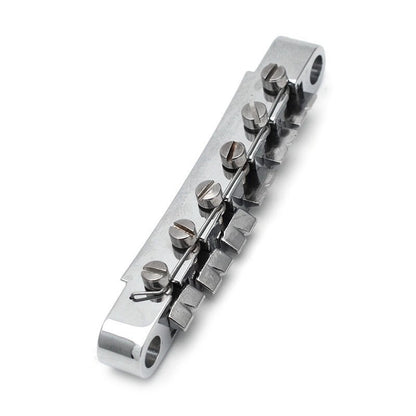 Electric Guitar bridge in chrome against a white background.