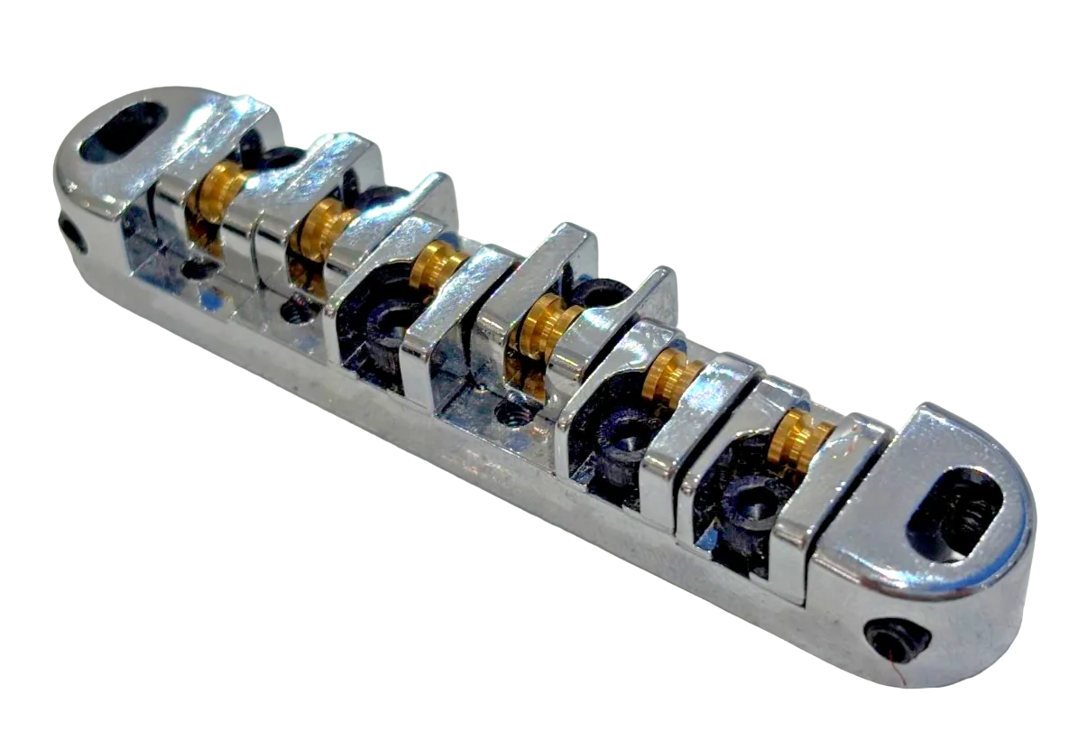 Chrome electric guitar roller bridge on a white background.