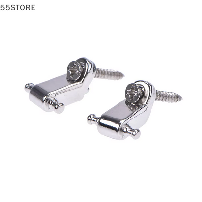 Two Chrome Guitar String Trees on a white background