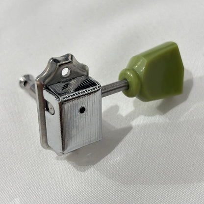 Chrome Keystone guitar tuner / machine head with green buttons on a white background