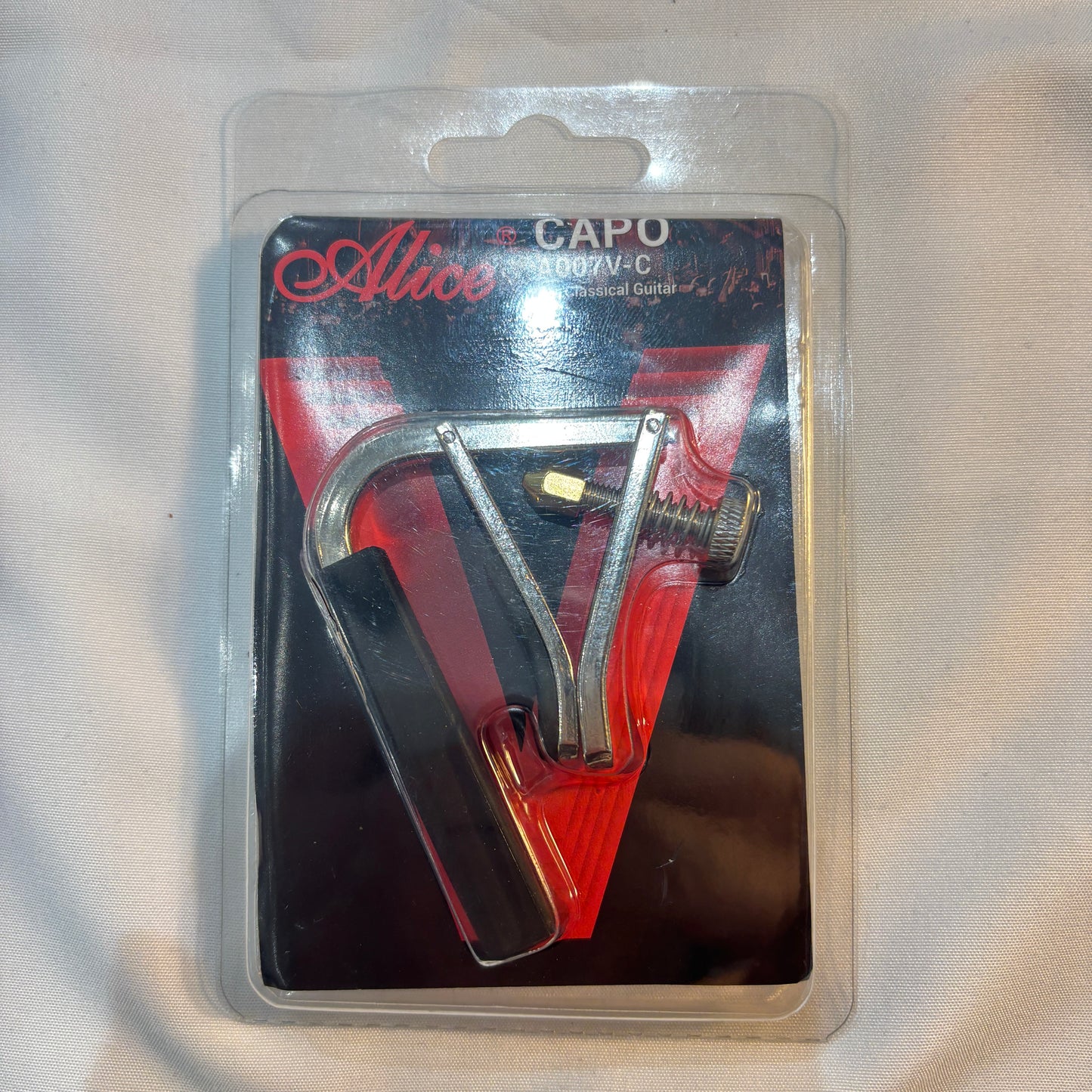 Alice classical guitar capo in packaging.