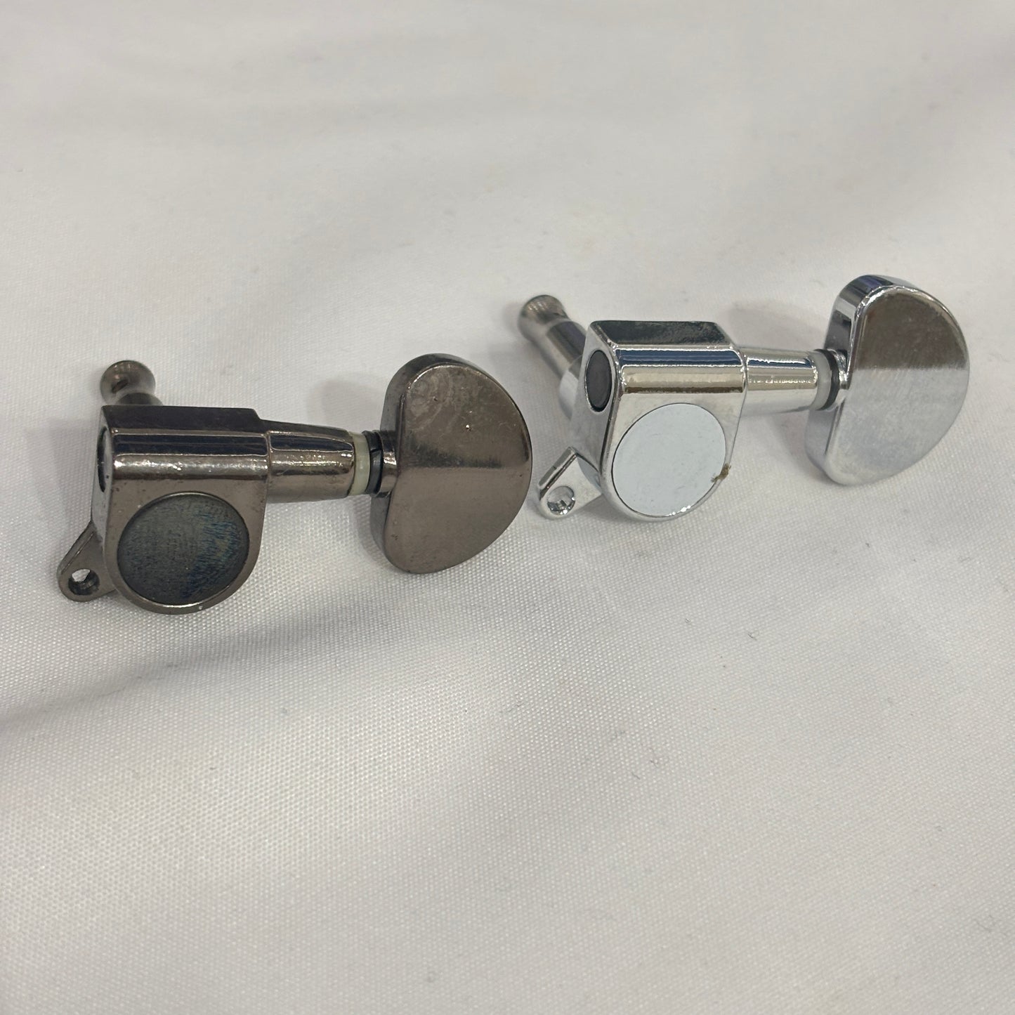 Dark Nickel and Chrome guitar tuner / machine head with kidney shaped button on a white background