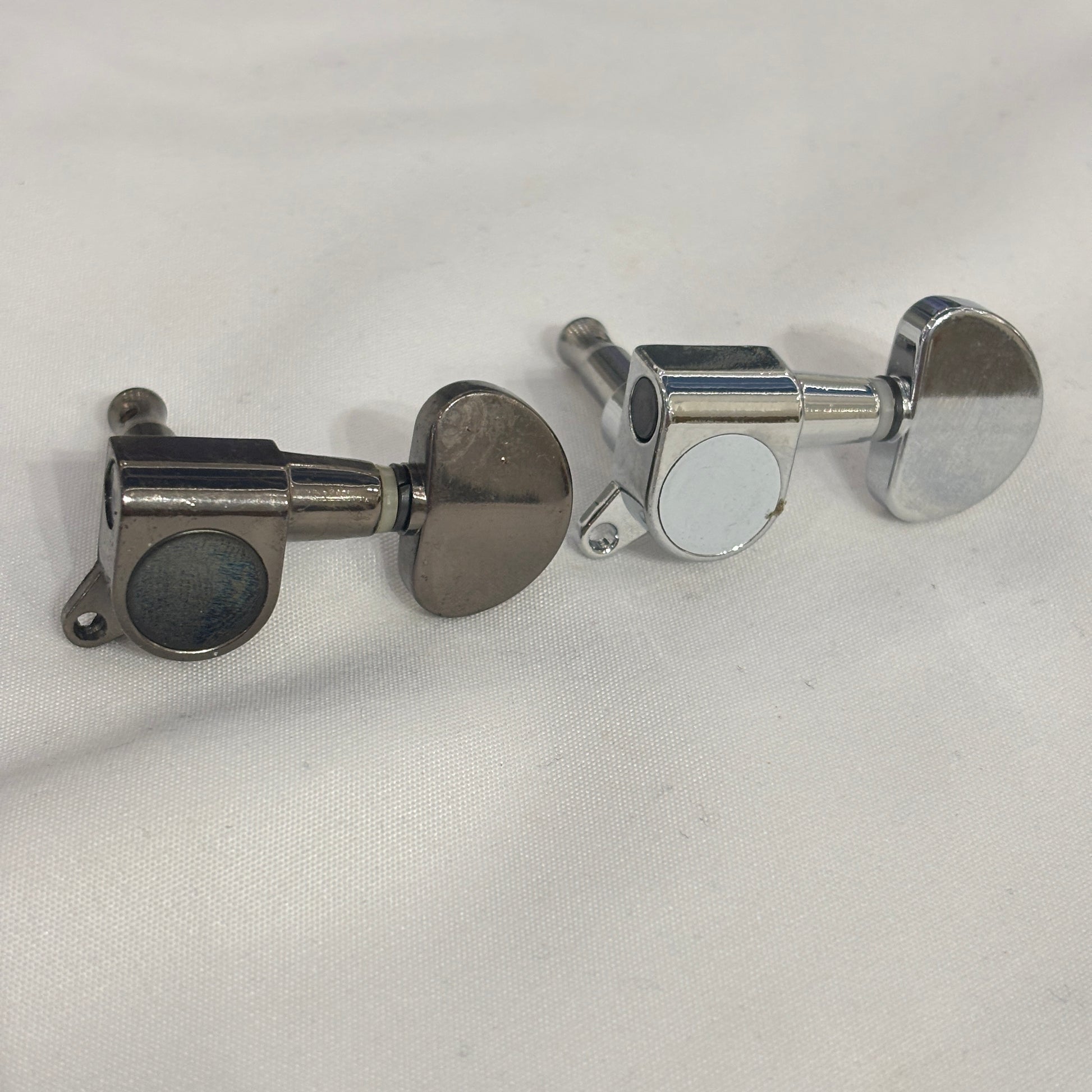 Dark Nickel and Chrome guitar tuner / machine head with kidney shaped button on a white background