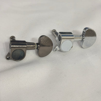 Dark Nickel and Chrome guitar tuner / machine head with kidney shaped button on a white background