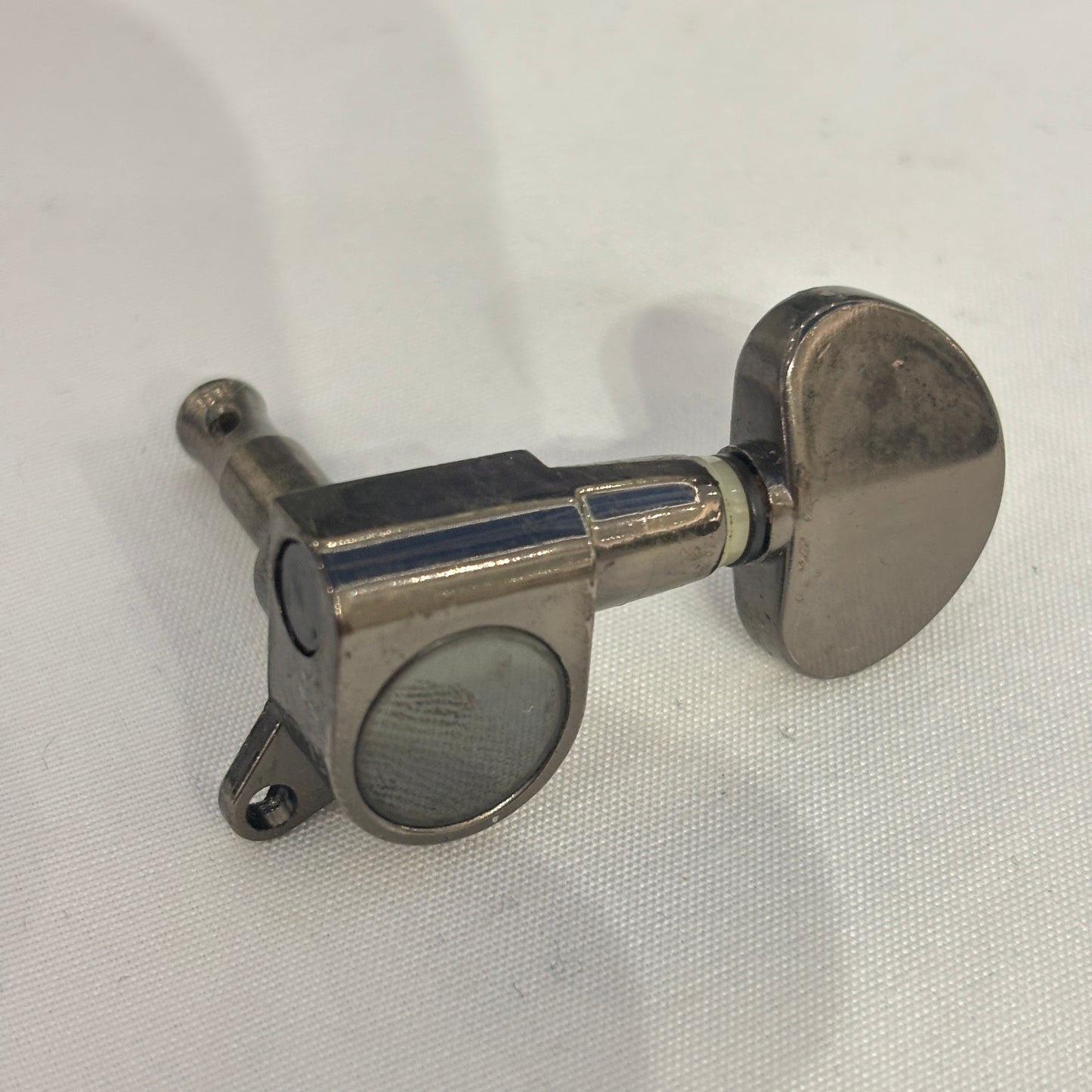 Dark Nickel guitar tuner / machine head with kidney shaped button on a white background