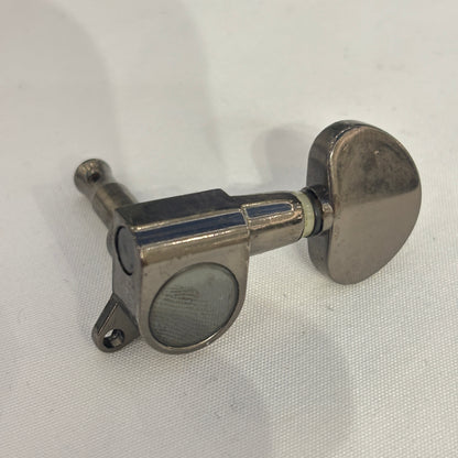 Dark Nickel guitar tuner / machine head with kidney shaped button on a white background