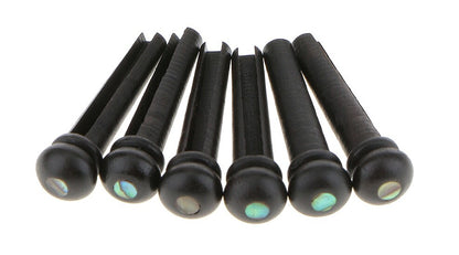 Six Ebony Acoustic Guitar Bridge Pins with Abalone dots against a white background.