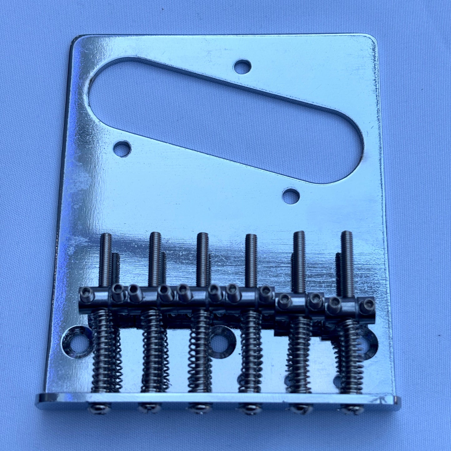 A chrome modern electric guitar bridge, TL-style on a white background.