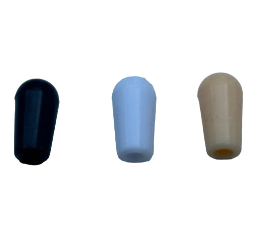 Electric guitar toggle switch tips in black, white and cream on a white background.