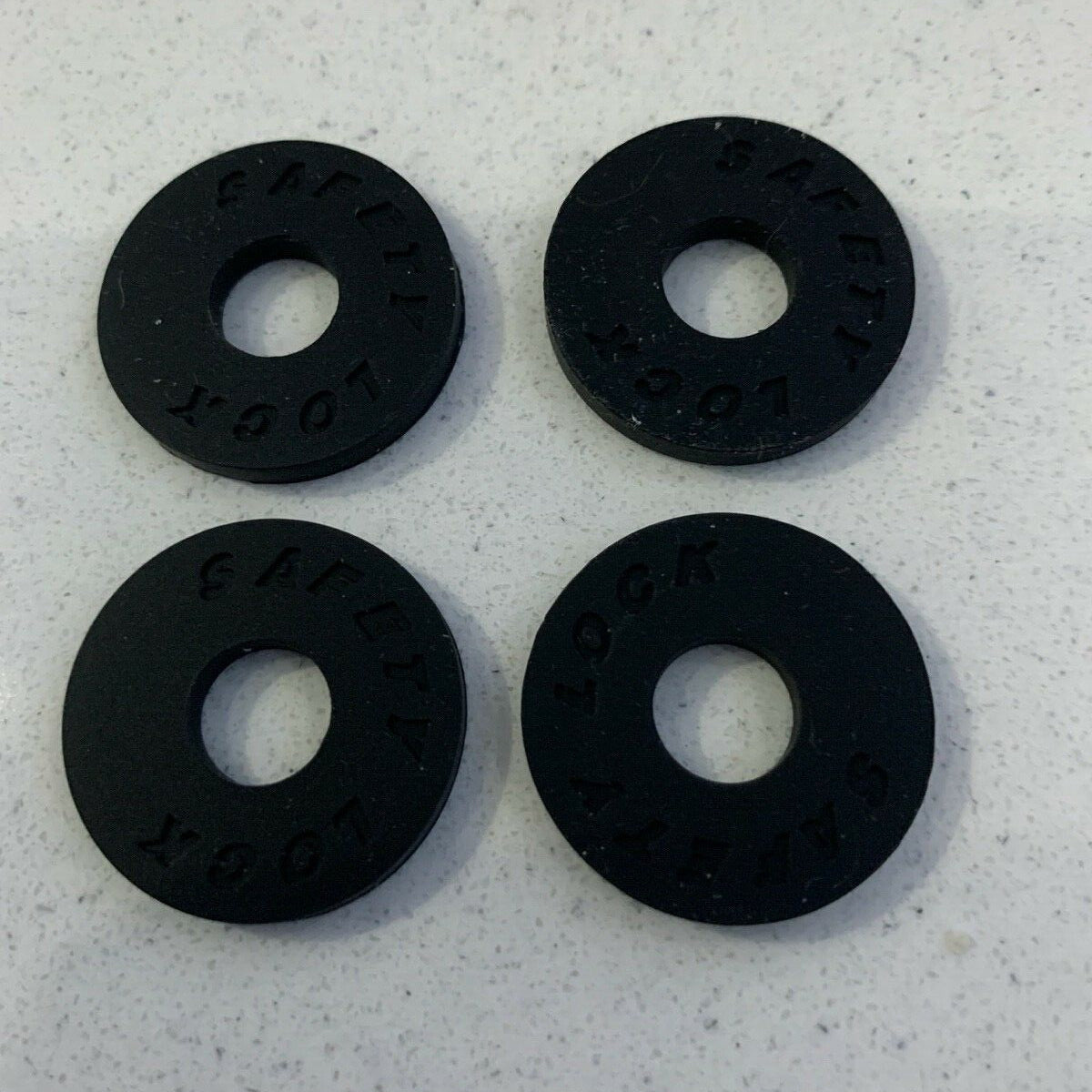 Four Black Rubber Strap Locks on a white background.