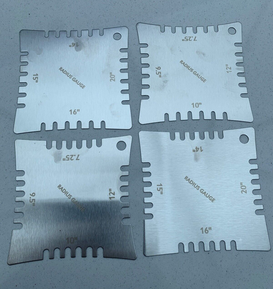 The rear of Four Guitar Notched Radius Gauges photographed on a  grey background