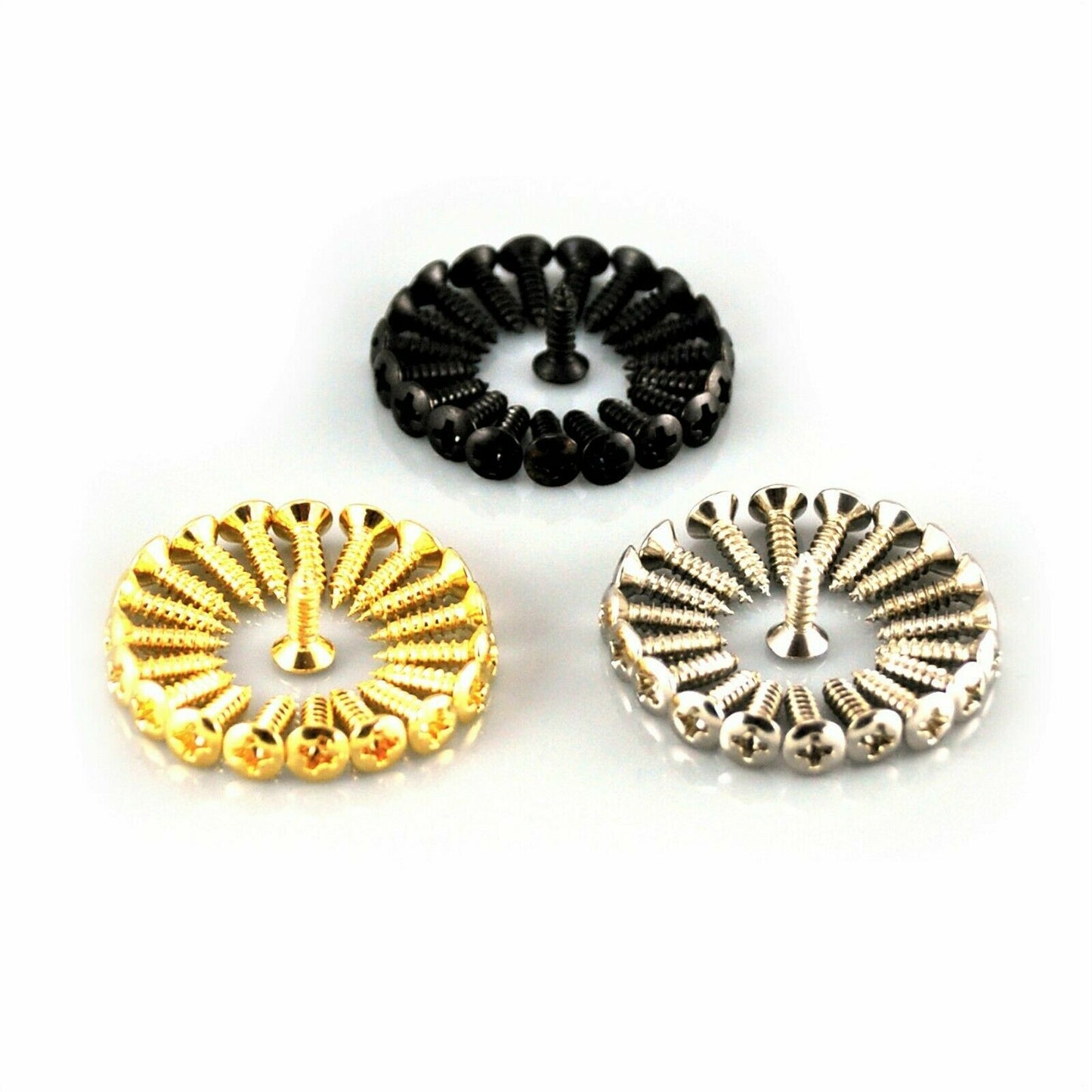 Gold, Black and Chrome Guitar Pickguard Screws on a white surface.