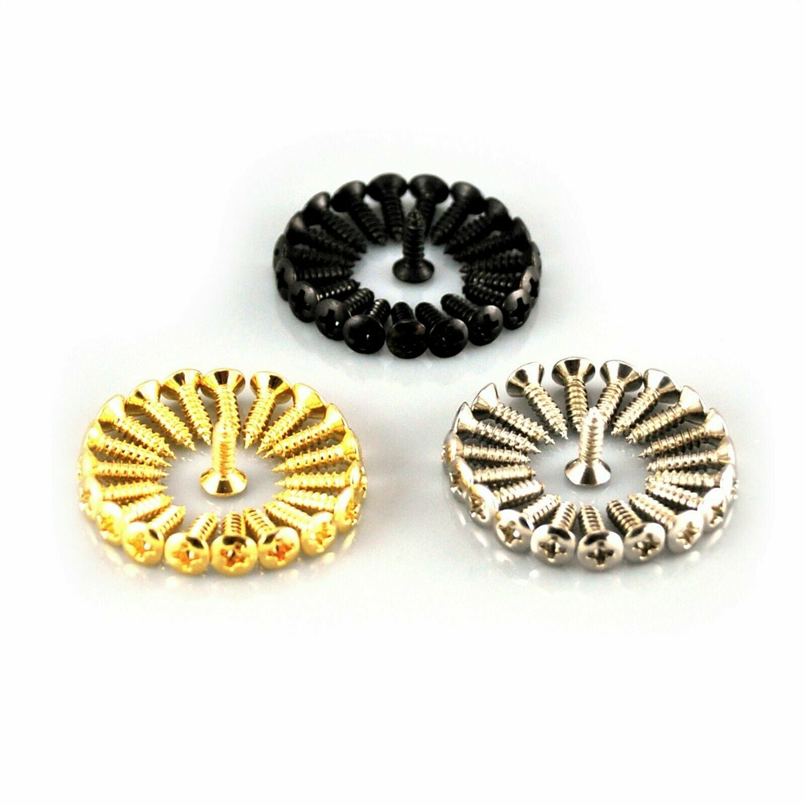 Gold, Black and Chrome Guitar Pickguard Screws on a white surface.