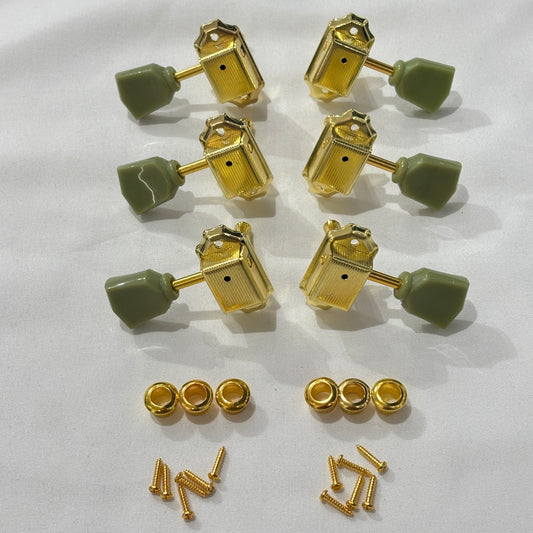 Set of gold Keystone guitar tuners / machine heads with green buttons on a white background