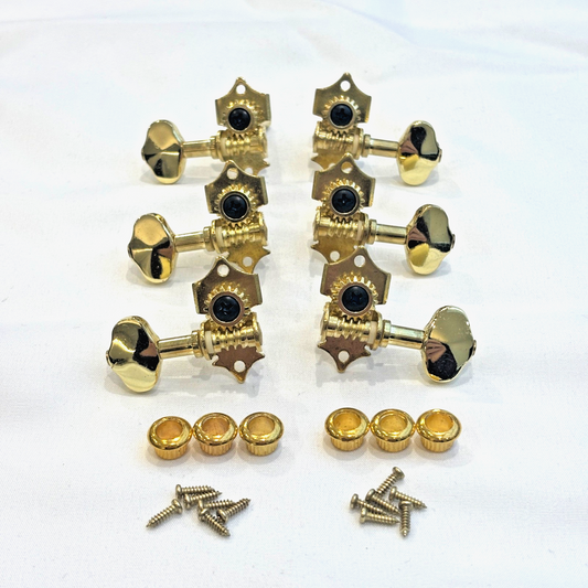 Set of six gold vintage open back acoustic guitar machine heads and related parts on a white background