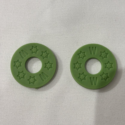 Two Green Rubber Guitar Strap Locks on a light grey background.
