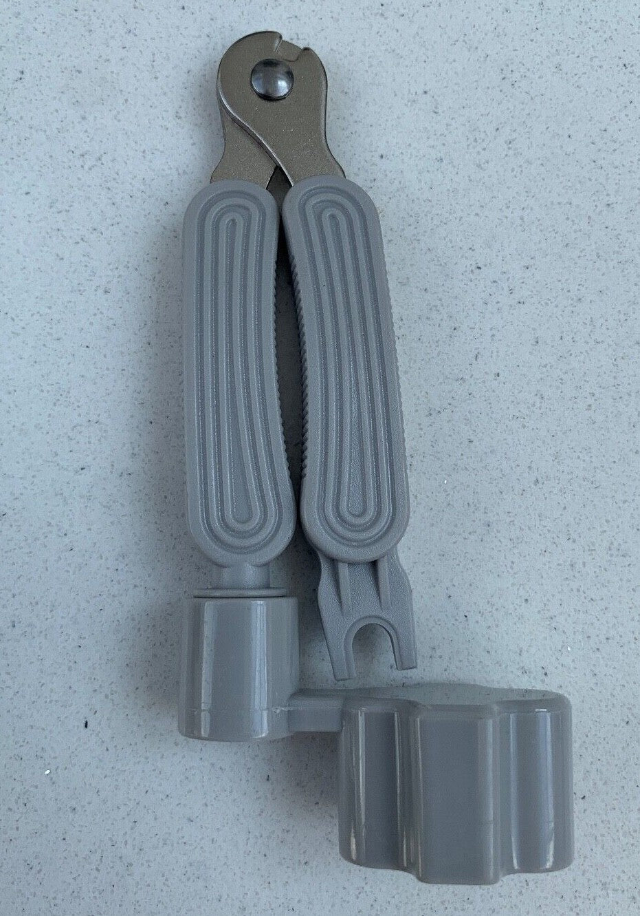 Grey Guitar Multi Tool against a light grey background.