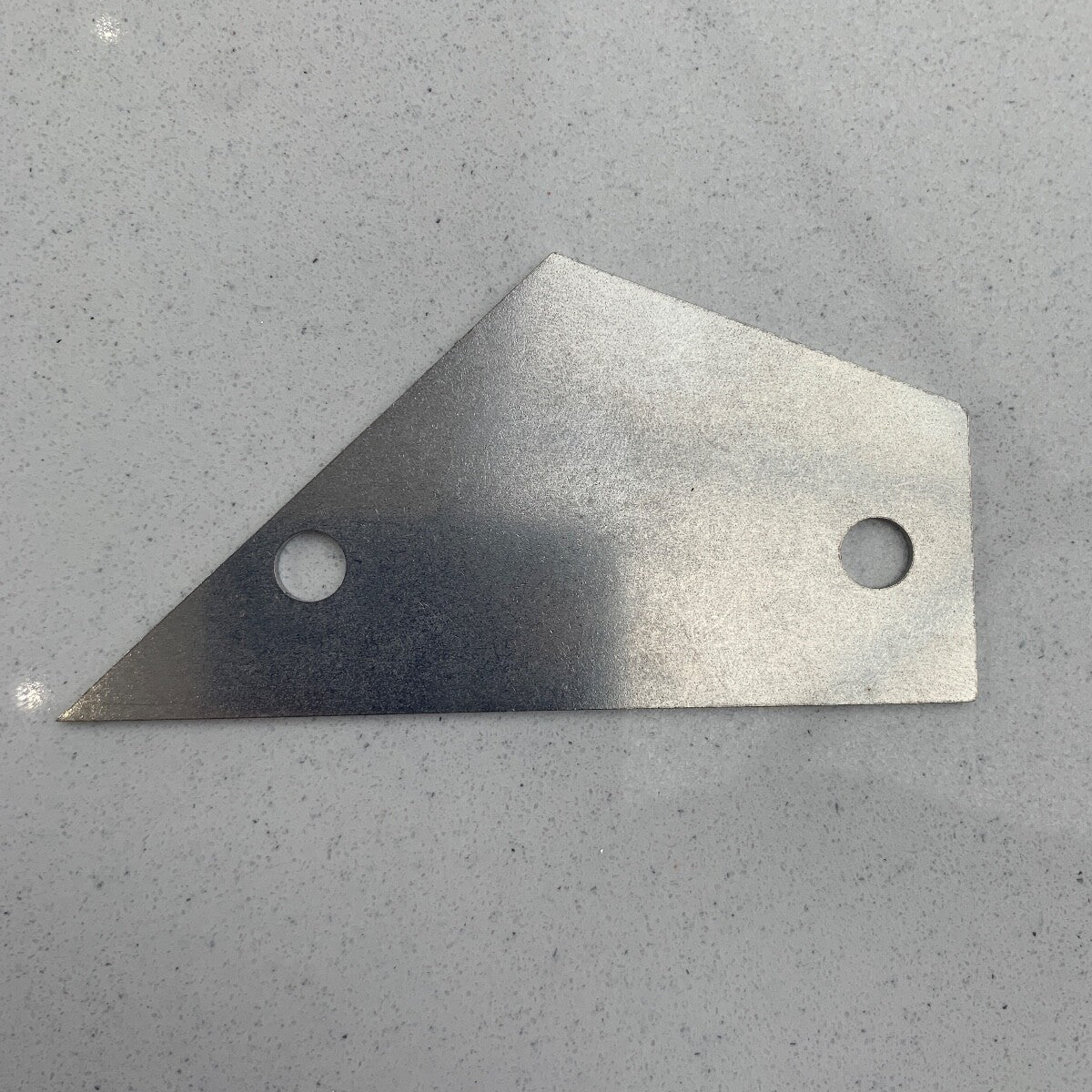 Guitar Fret Rocker photographed flat on a grey surface.