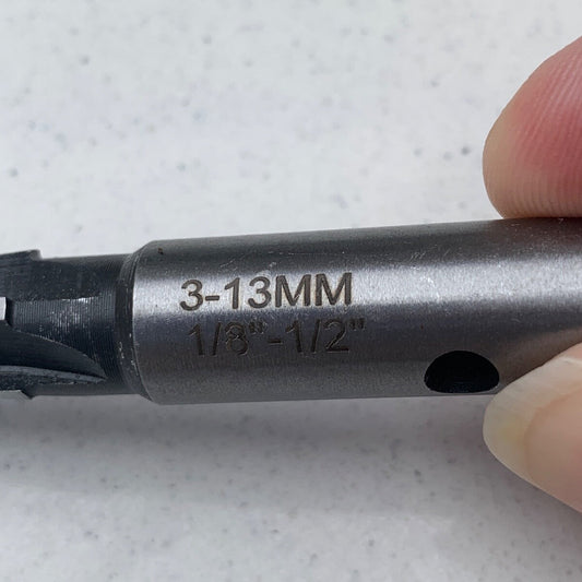 Close up of the metric size of a Guitar Hole Reamer against a grey background.