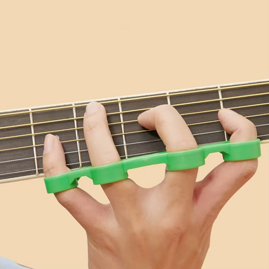 A Guitar Finger Stretcher in use on a guitar on a beige background.