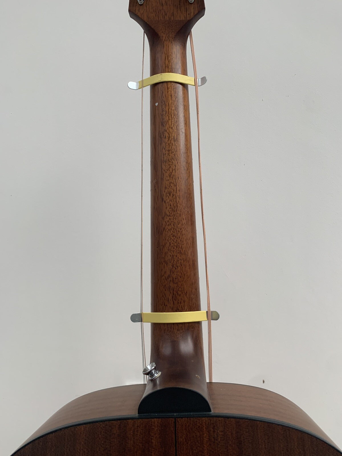 Rear view of a guitar's neck with a pair of String Spreaders attached.
